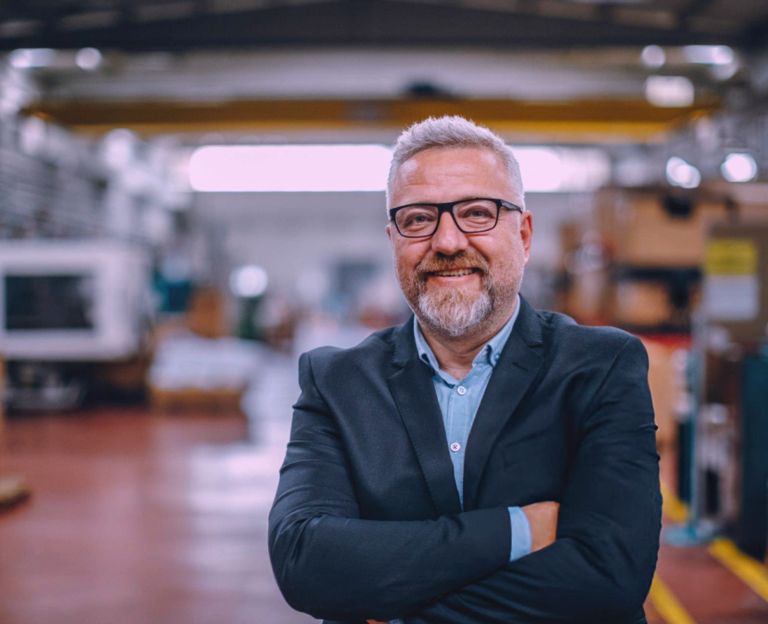 Owner discussing strategies with team members in a conference room